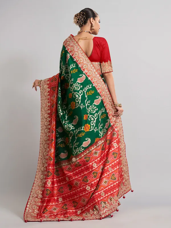 Green hyderabadi patola silk saree with contrast border work