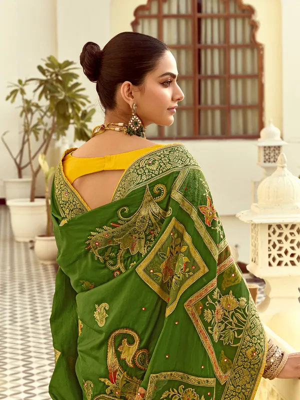 Green silk saree with colorful motif weaving
