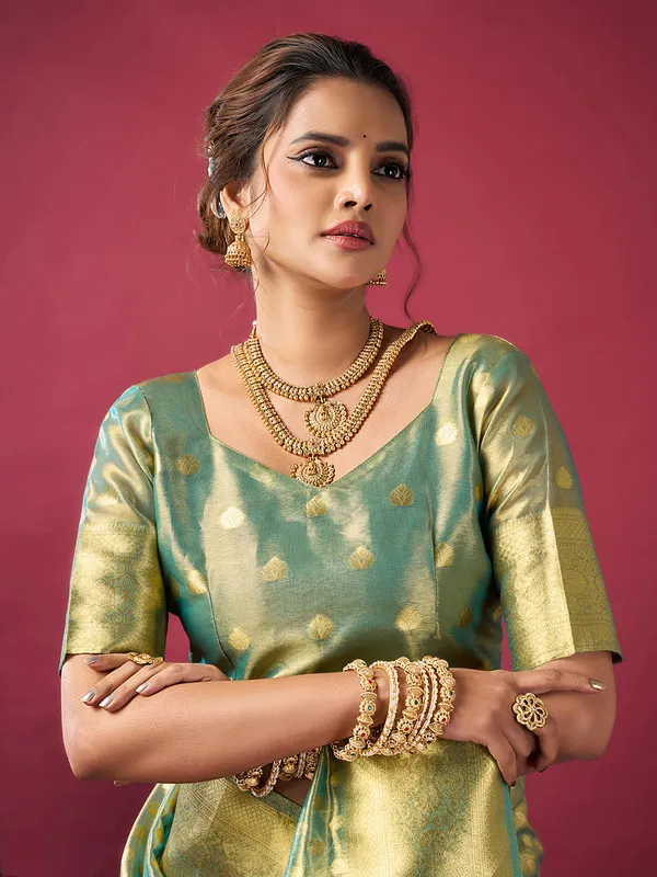 Green silk saree with zari glow