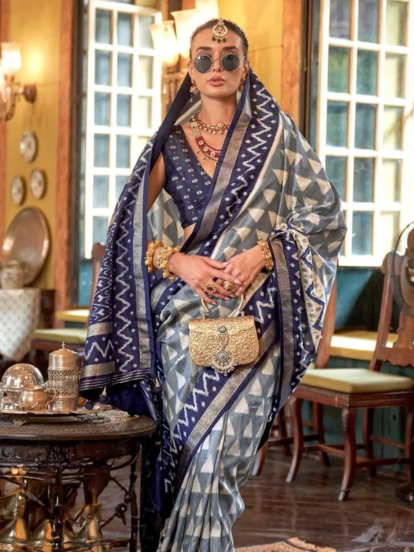 Grey silk printed saree with bold blue border