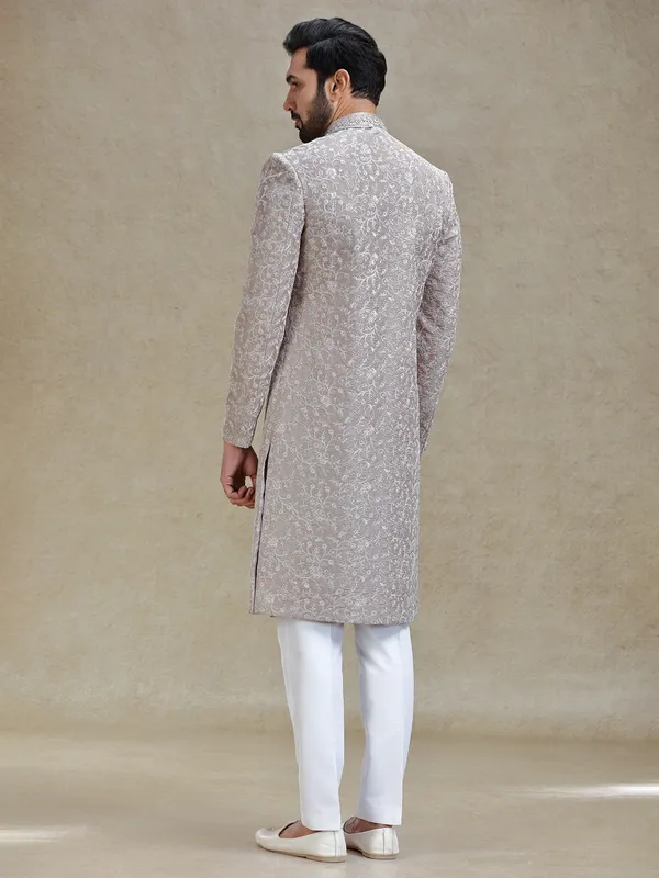 Grey silk sherwani in heavy stylish motifs