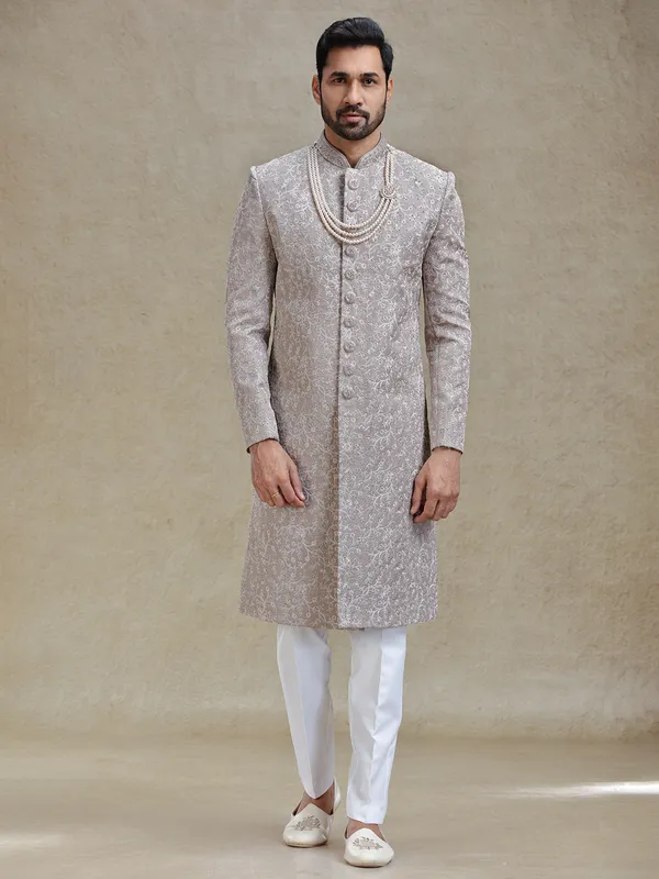 Grey silk sherwani in heavy stylish motifs
