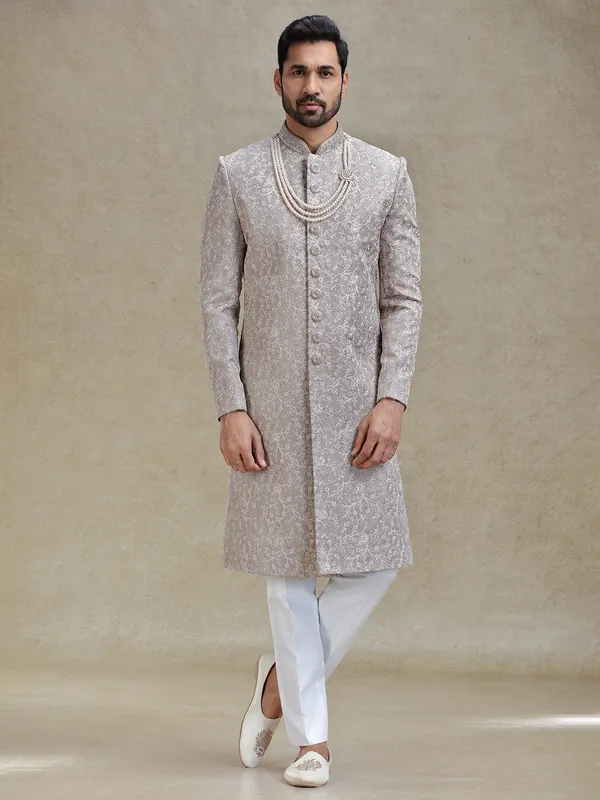 Grey silk sherwani in heavy stylish motifs
