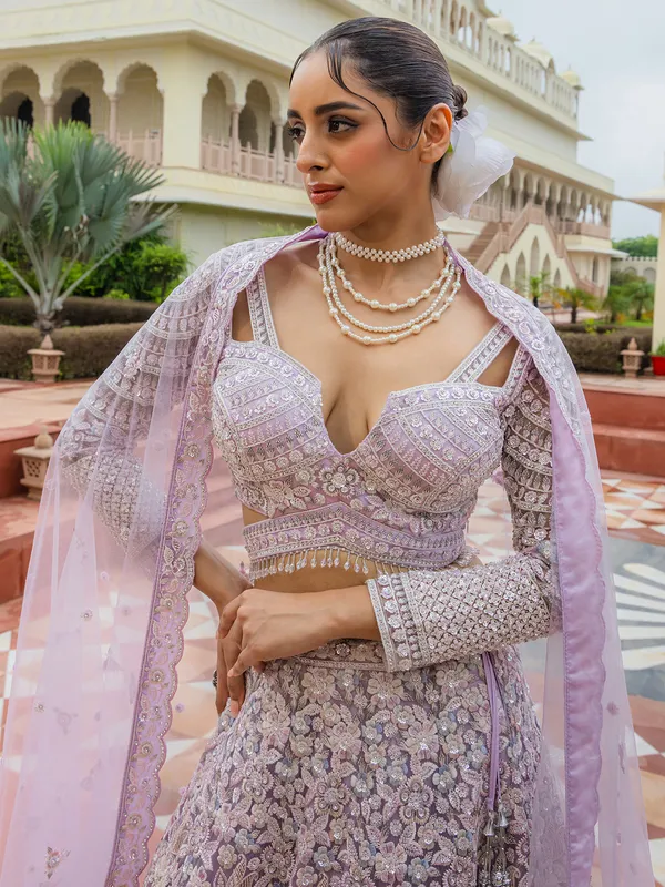 Lilac purple thread worked net lehenga choli