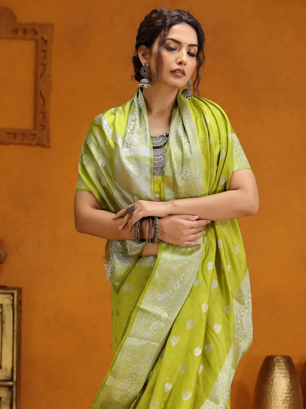 Lime green silk saree with silver zari weaving