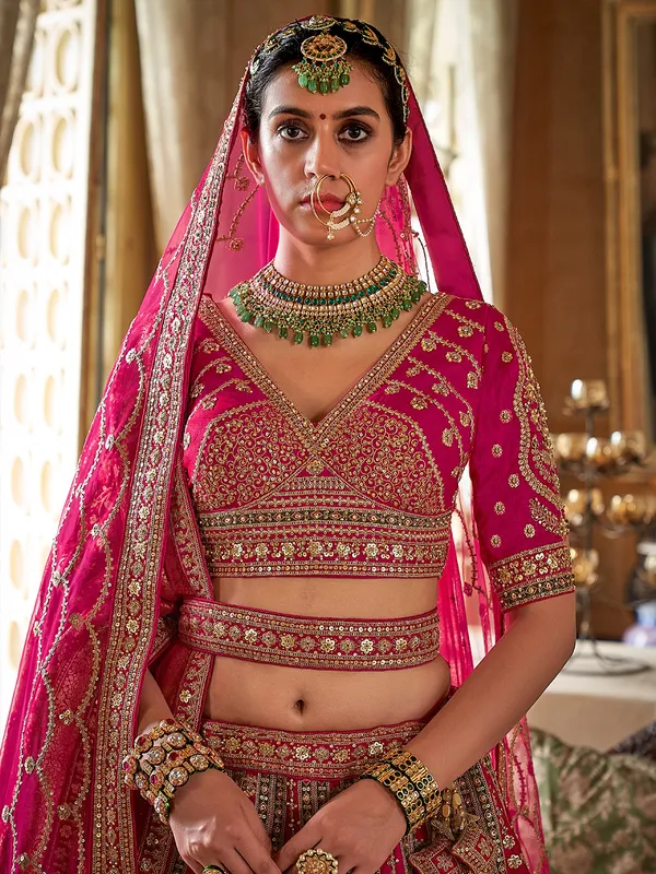 Magenta silk bridal lehenga choli with rich sequins embellishment
