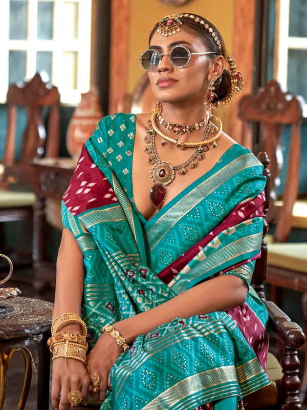 Maroon printed silk saree with contrast aqua border