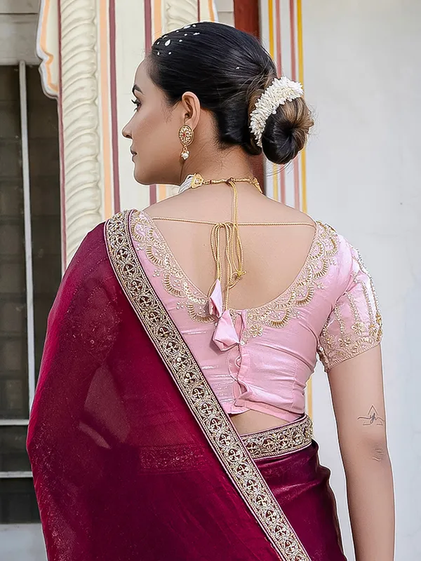 Maroon satin saree adorned with festive accents