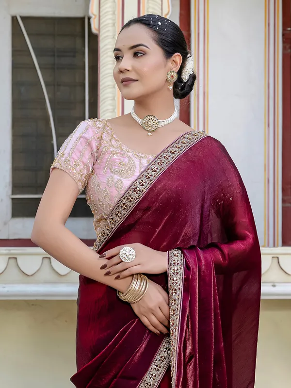 Maroon satin saree adorned with festive accents