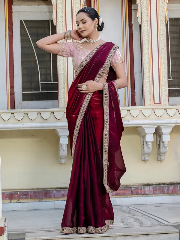 Maroon satin saree adorned with festive accents