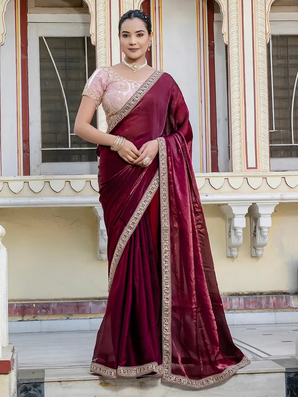 Maroon satin saree adorned with festive accents