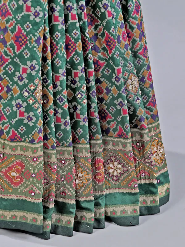 Mehendi green printed saree with traditional embellishments