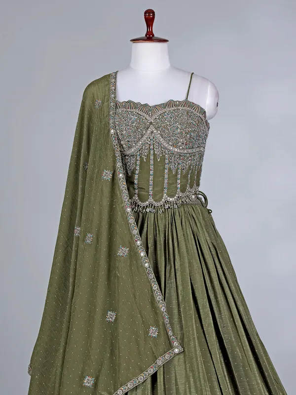 Mehendi green silk lehenga choli with cutdana glow