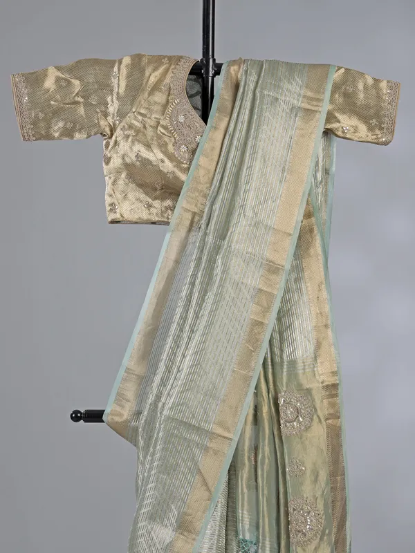 Mint green tissue silk saree with zari detailing