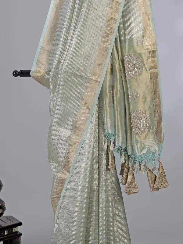 Mint green tissue silk saree with zari detailing