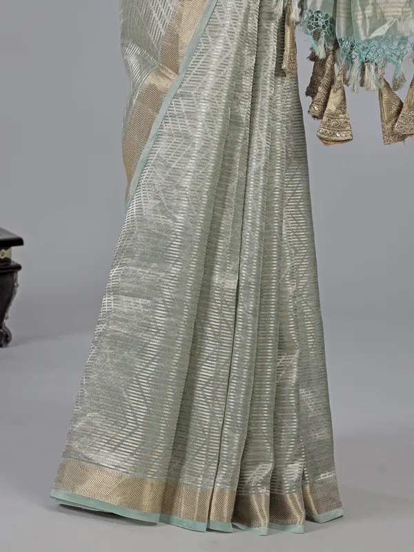Mint green tissue silk saree with zari detailing
