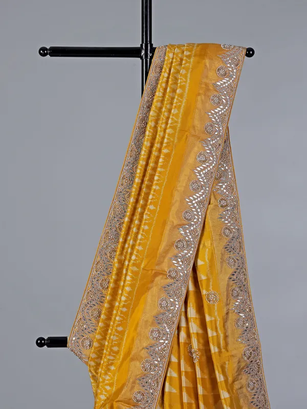 Mustard yellow patola silk saree with beads embellishments