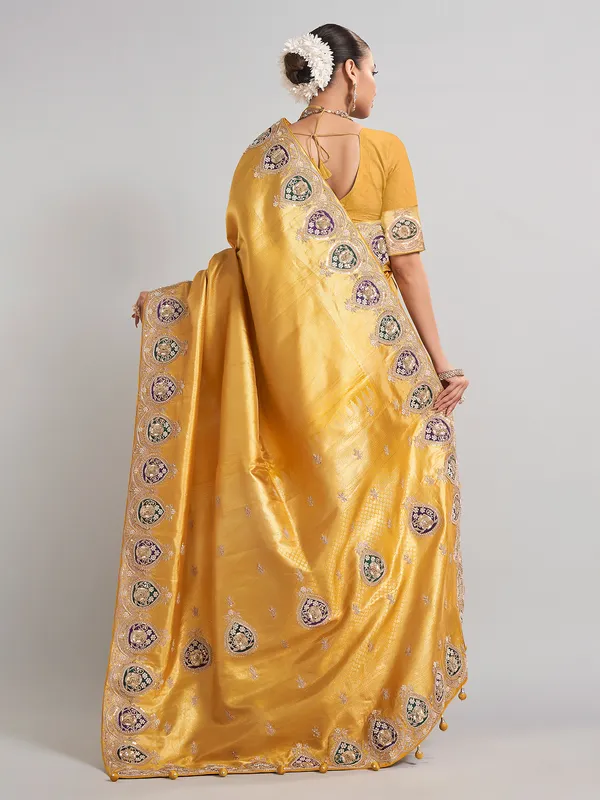 Mustard yellow tissue silk saree with rich embellished work