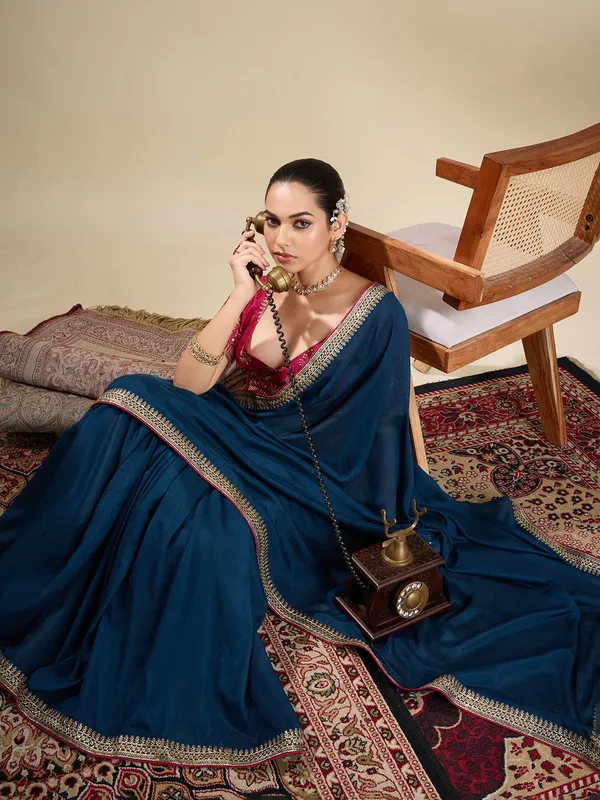 Navy silk plain saree with embellished border