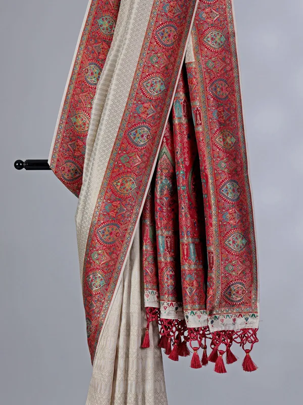 Off white dola silk saree with colorful motifs
