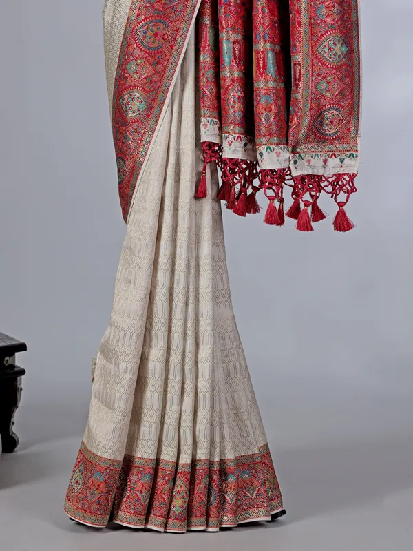 Off white dola silk saree with colorful motifs