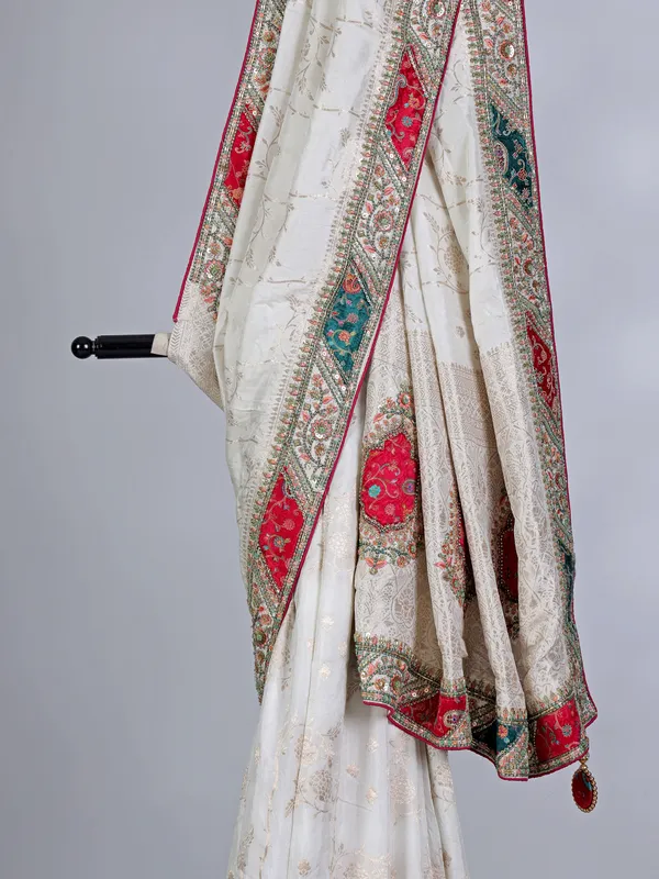 Off white dola silk saree with stone and thread embellishments