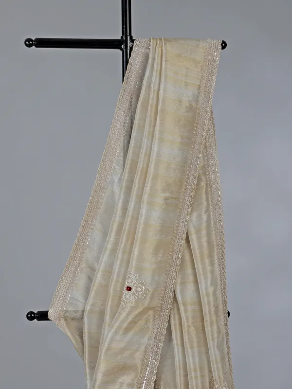 Off white dola tissue silk saree with zari work