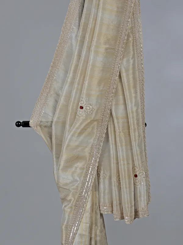 Off white dola tissue silk saree with zari work