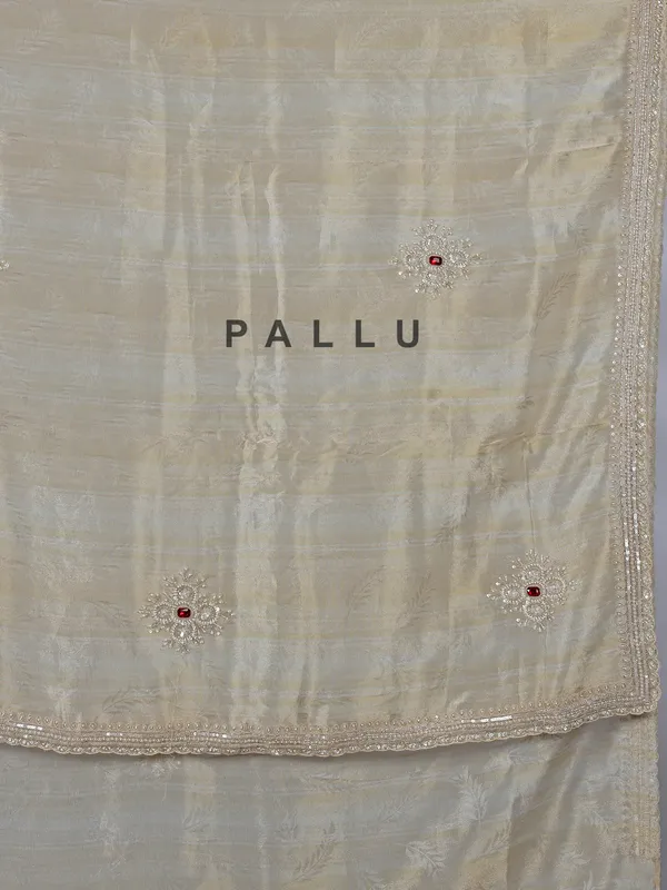Off white dola tissue silk saree with zari work
