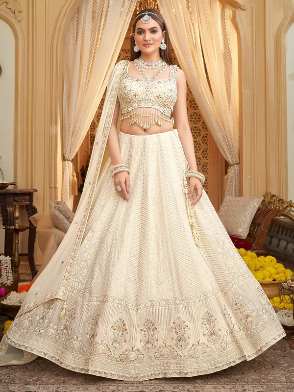 Off white silk lehenga choli with cowrie shells