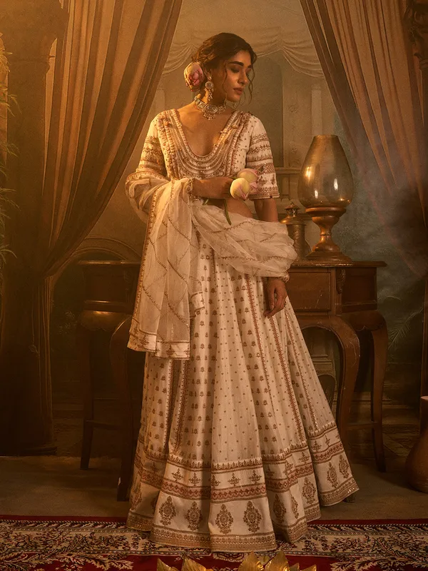Off white silk wedding wear lehenga choli with beads detailing