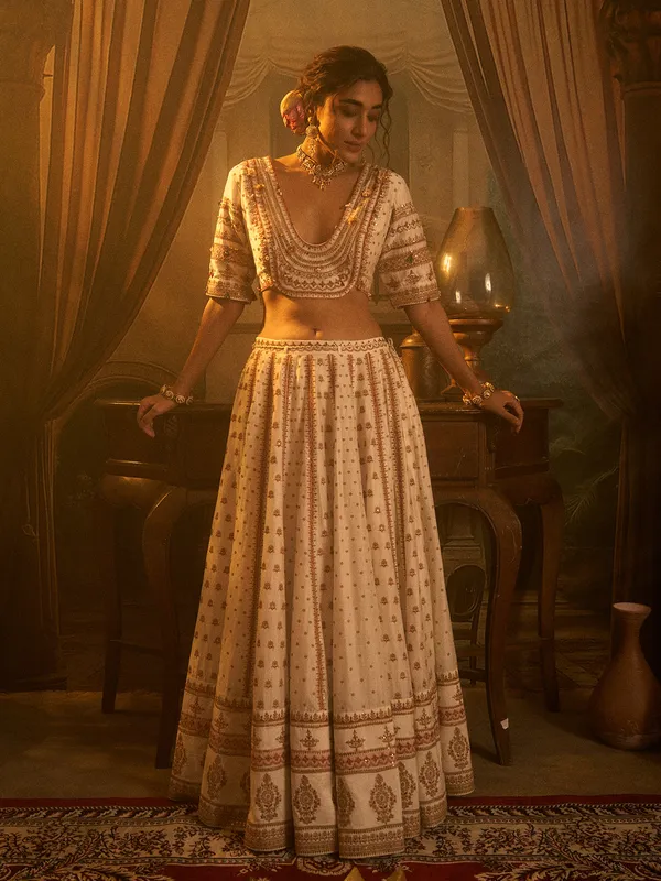 Off white silk wedding wear lehenga choli with beads detailing