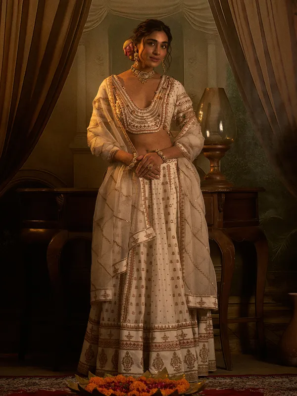 Off white silk wedding wear lehenga choli with beads detailing