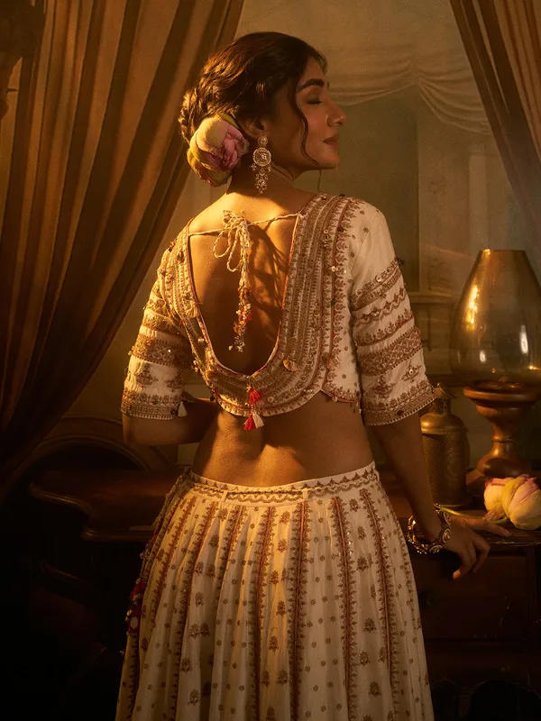 Off white silk wedding wear lehenga choli with beads detailing