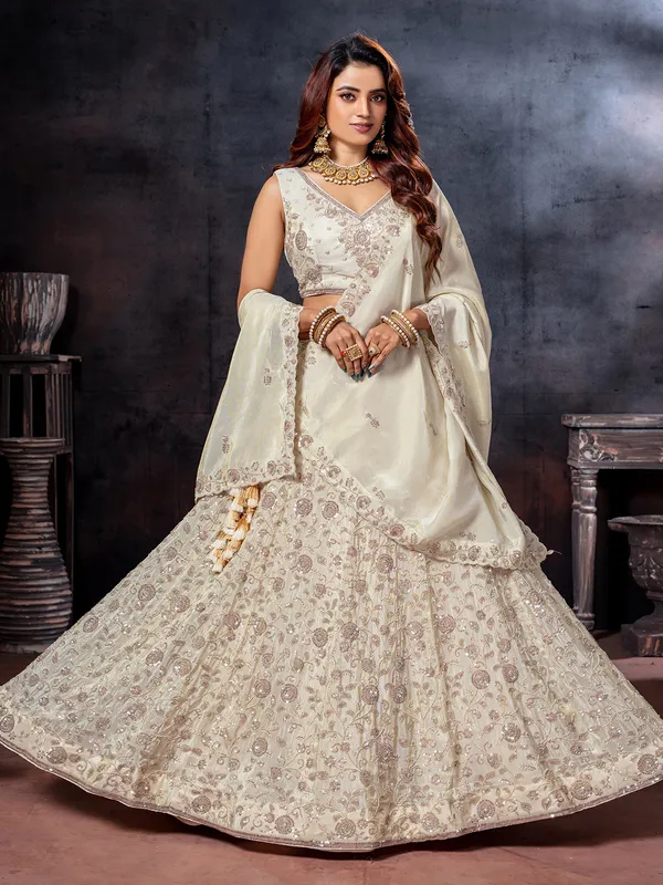 Off white sleeveless tissue silk lehenga choli