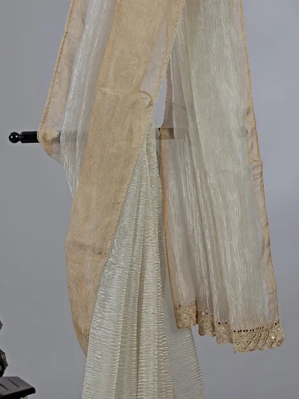 Off white tissue silk saree with elegant embellishments