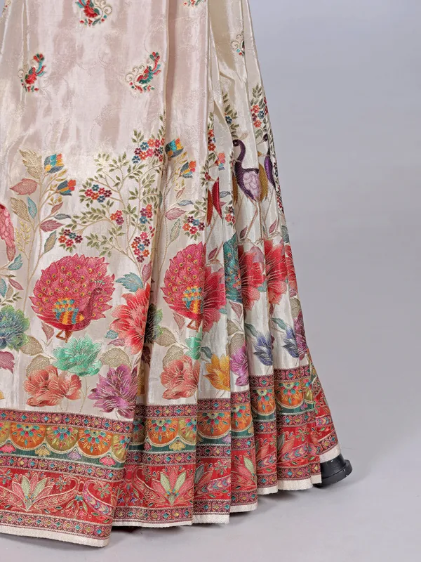 Off white tissue silk saree with floral accents