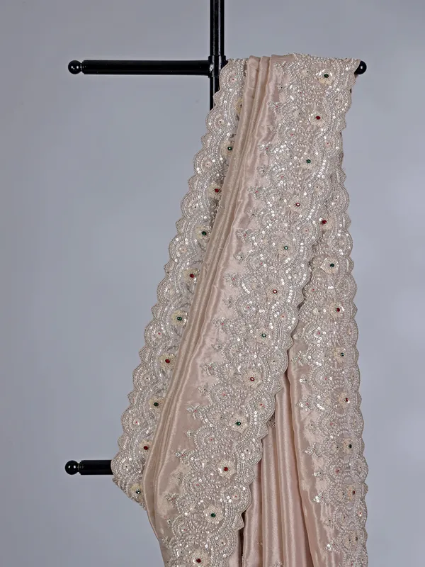 Off white tissue silk saree with sparkling stone and cutdana accents