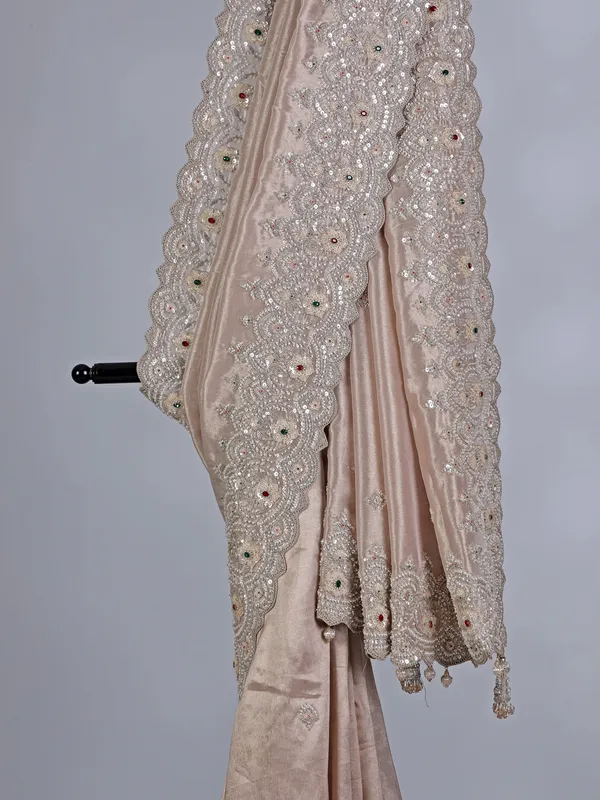 Off white tissue silk saree with sparkling stone and cutdana accents