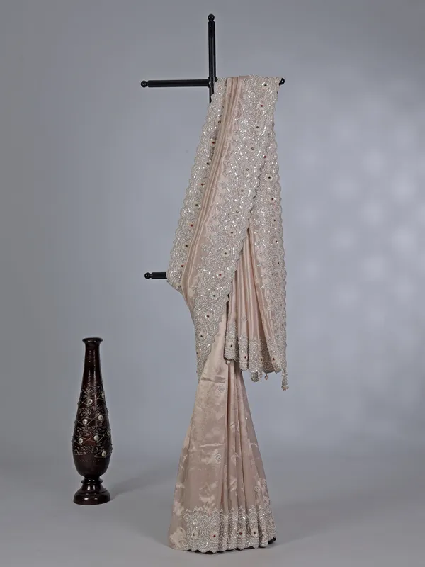 Off white tissue silk saree with sparkling stone and cutdana accents
