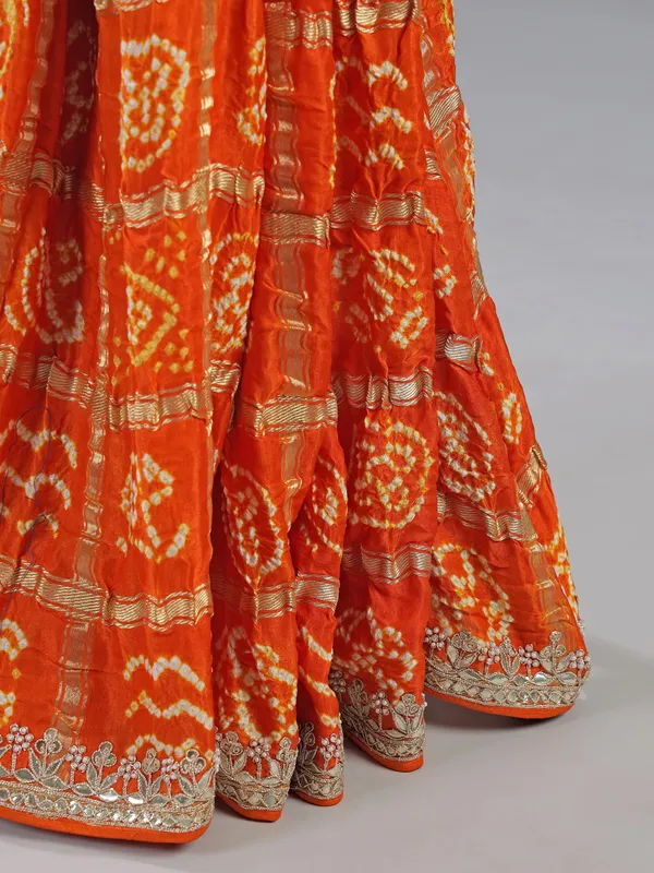 Orange bandhani saree with beaded detailing