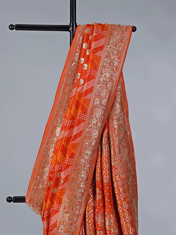 Orange dola silk saree with bandhej print