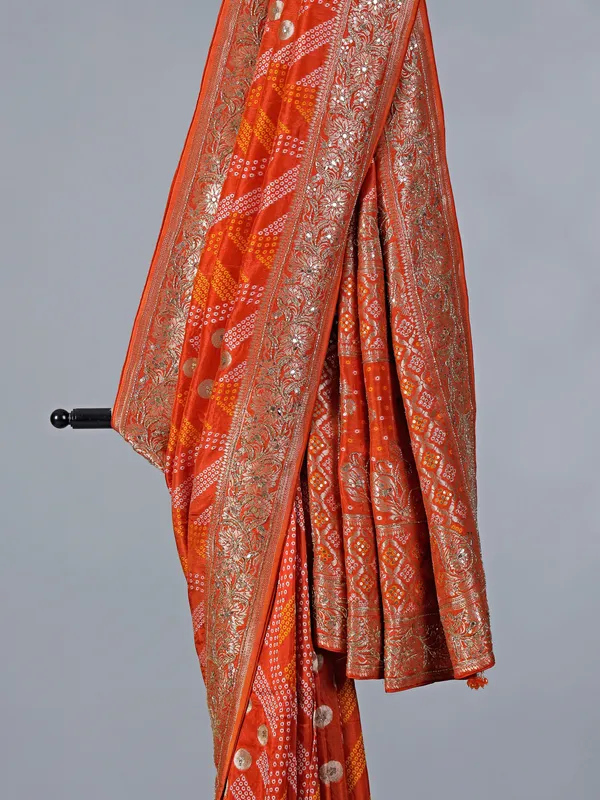 Orange dola silk saree with bandhej print