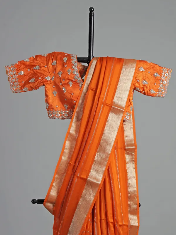 Orange organza satin saree with stone studded blouse