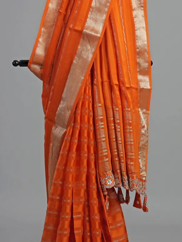 Orange organza satin saree with stone studded blouse