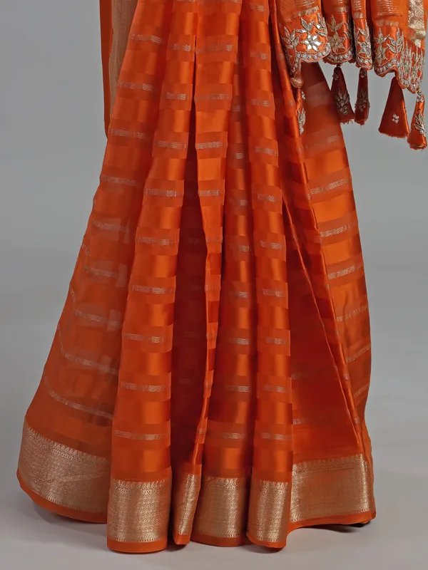 Orange organza satin saree with stone studded blouse