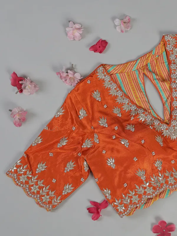 Orange organza satin saree with stone studded blouse