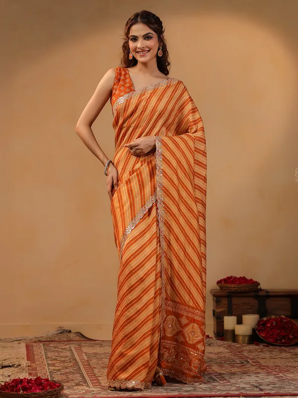 Orange printed silk saree with aabla accents