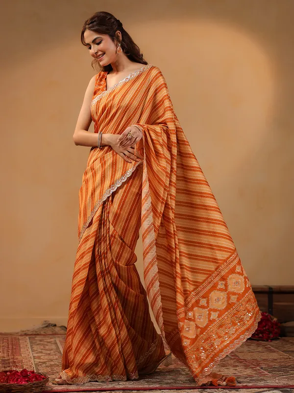 Orange printed silk saree with aabla accents