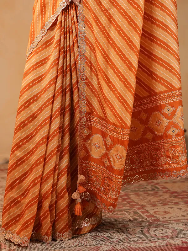 Orange printed silk saree with aabla accents